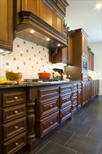 Custom kitchen cabinetry with hood.