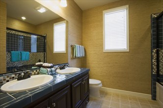 Bathroom with two sinks and tile floor.