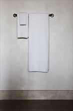 Detail of white towels on a towel rack