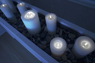 Night scene with lit candles in stones