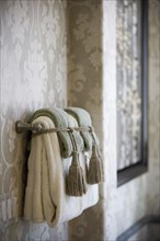 Handle towels on towel bar tied with tassels