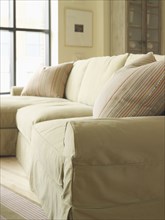 Light colored sofa with striped throw pillow