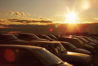 Sunset over cars in parking lot