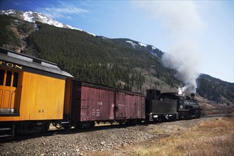 Steam train near mountain
