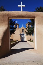 Crosses and entrance of adobe church