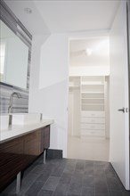 Door open to walk-in closet from modern bathroom