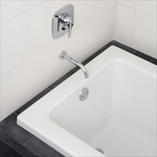 Close up of faucet and bathtub in modern bathroom
