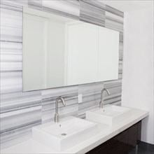 Sinks and mirror in modern bathroom