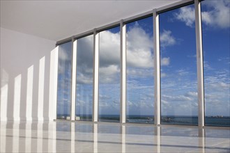 Blue sky viewed through windows in modern apartment
