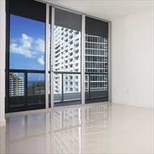 Glass doors and balcony of empty modern apartment