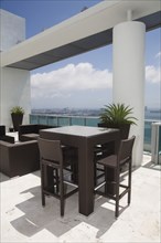 Table and chairs on modern balcony
