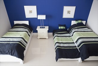 High angle view of trundle and twin beds in bedroom