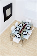 High angle view of set table and chairs in modern dining room