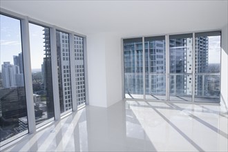 Windows of empty modern apartment overlooking cityscape