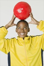 African boy holding soccer ball