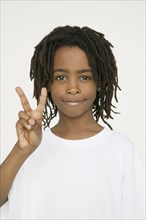 African boy making peace sign with hand