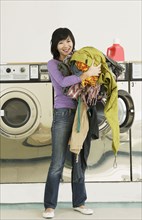 Asian woman in laundromat