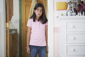 Hispanic girl standing in doorway