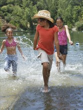 Young girls splashing in lake