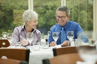Business people working at table in restaurant