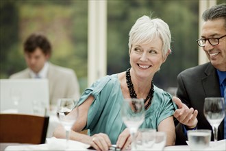 Smiling business people working at table in restaurant