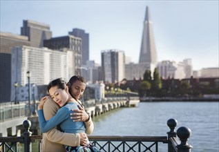 Couple hugging at waterfront