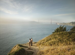 Couple admiring scenic view of bay