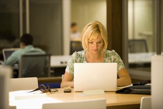 Caucasian woman using laptop in office