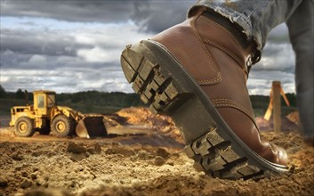 Close up of worker's boot on construction site