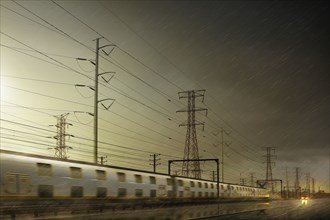 Train speeding by power lines