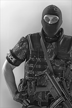Policeman wearing machine gun and vest