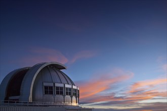 Observatory under colorful sunset sky