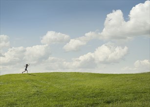 Girl running in rural landscape