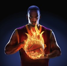 African American man holding flaming basketball