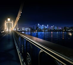 Railing on urban bridge at night