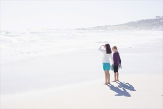 Caucasian girls standing on bright beach