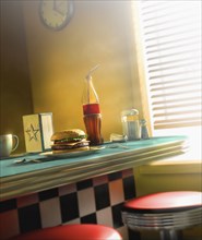 Burger and soda on diner counter