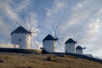 Bare windmills in rural landscape