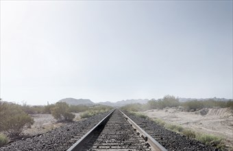 Train tracks in dusty rural landscape