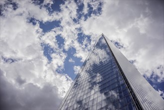 Low angle view of clouds reflected in skyscraper