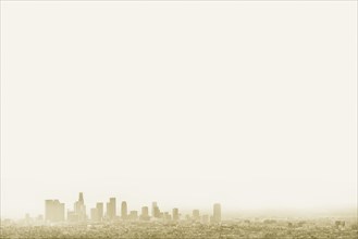Silhouette of city skyline in hazy sky