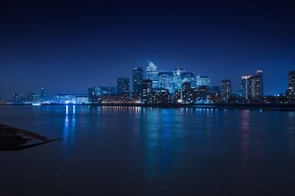 Illuminated skyline in cityscape at night