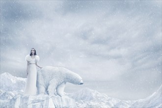 Woman and polar bear standing on glacier