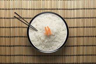 Chopsticks in bowl of white rice