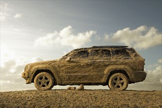 Sports utility vehicle covered in mud