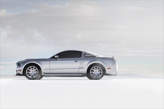 Silver sports car in white landscape