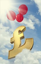 Red balloons lifting British pound symbol in cloudy sky
