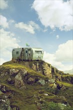 Motor home on hill in green landscape