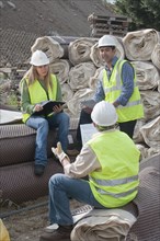 Hispanic construction workers having meeting outdoors