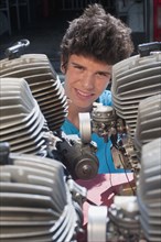 Hispanic teenager looking at engines